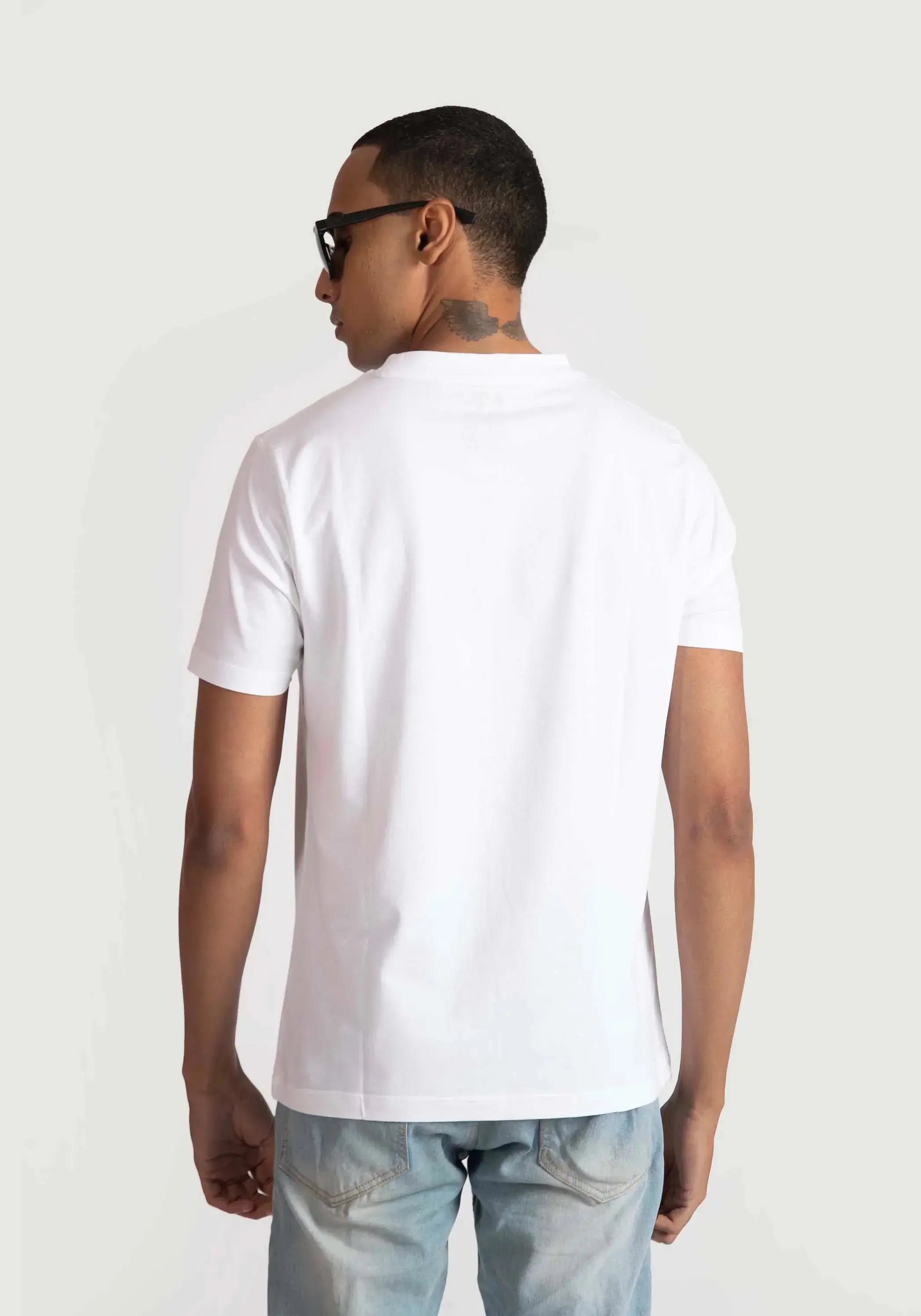 Stylera white regular fit t-shirt shown from back worn by male model with sunglasses