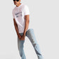 Stylera white regular fit t-shirt with graphic print worn by male model with sunglasses and light blue jeans