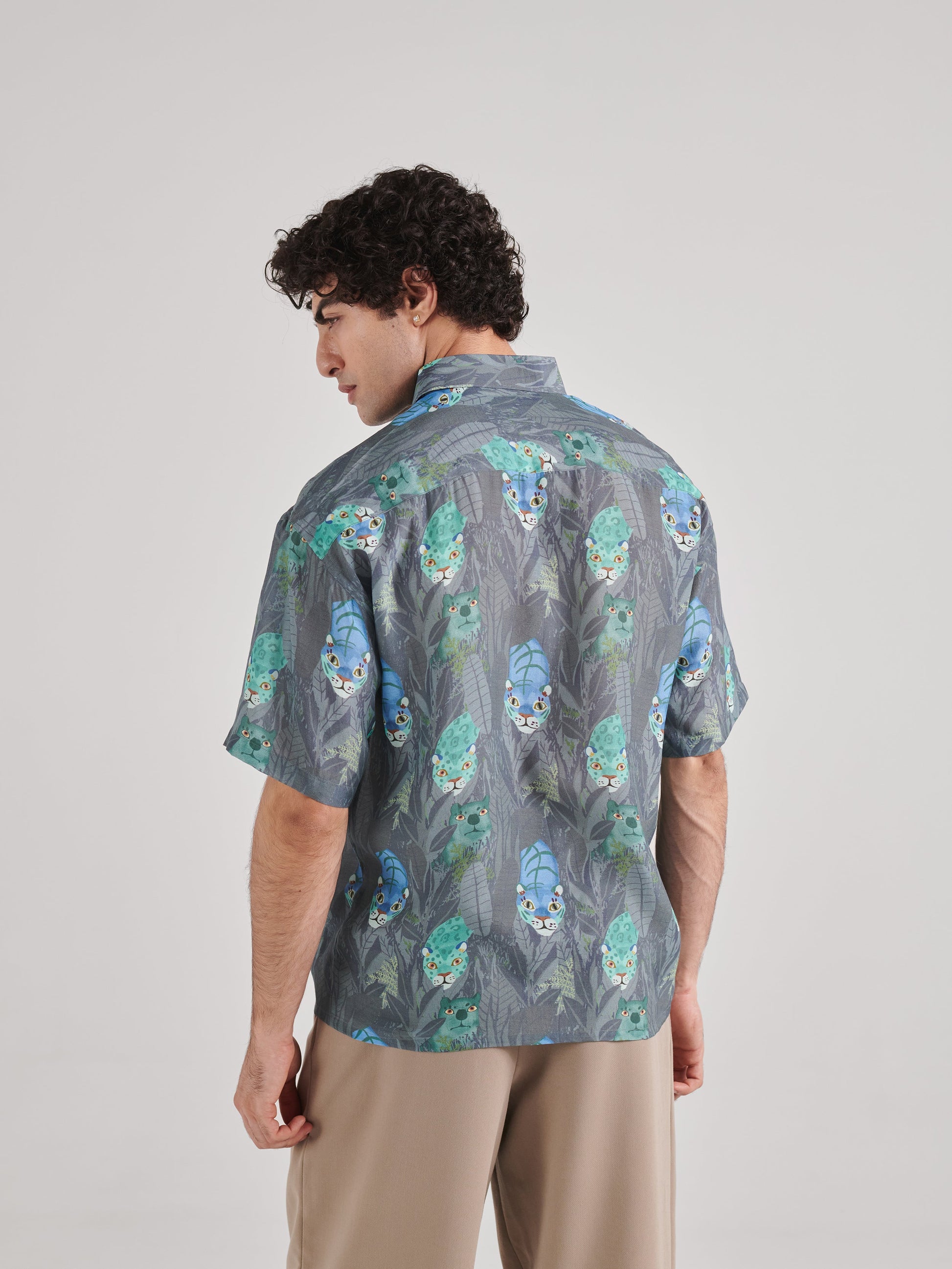 Back view of a Stylera drop shoulder shirt for men featuring a vibrant floral pattern