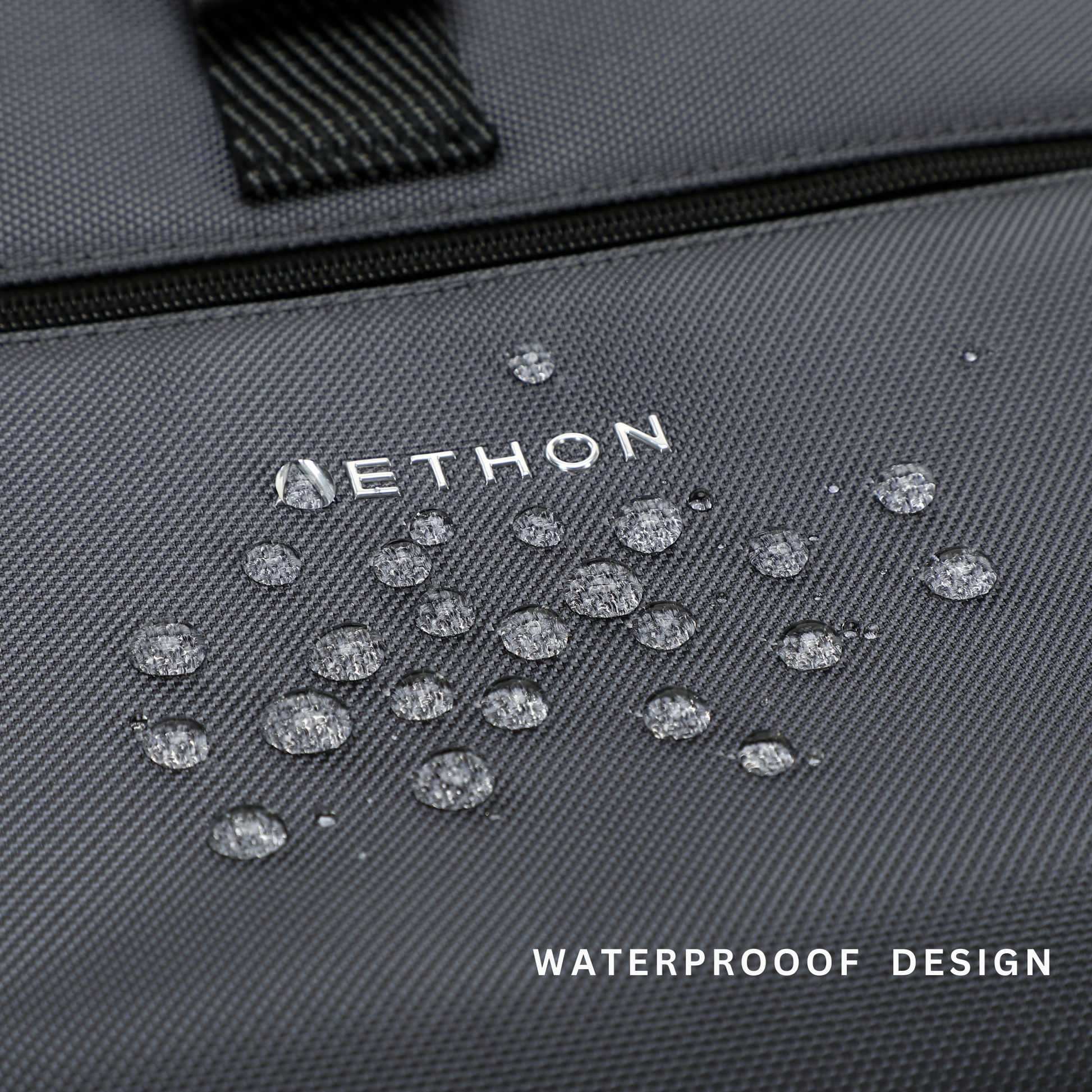 Stylera gray waterproof fabric close up with water droplets on logo showing durable laptop backpack for travel