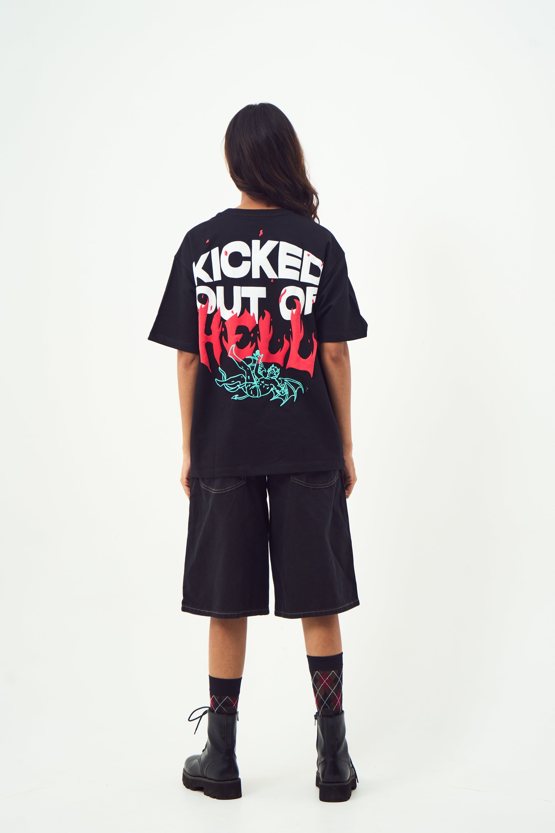 Model back view wearing black edgy graphic tee for men and women by Stylera with red teal hell print and black shorts