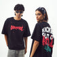 Two models wearing Stylera black tees showing front logo and flaming back print edgy graphic tee for men and women