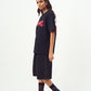Model wearing Stylera black oversized edgy graphic tee for men and women with knee length shorts and combat boots