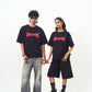 Stylera models holding hands wearing black shirts with red logo styled as edgy graphic tee for men and women