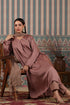Elegant long kurta with dupatta in soft fabric, styled with traditional earrings and a wooden chair