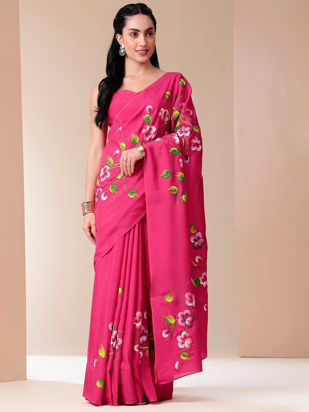 Elegant pink saree for parties featuring floral embroidery and a graceful drape