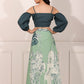 Back view of a woman wearing an ethnic crop top and skirt set featuring puffed sleeves and a floral printed skirt