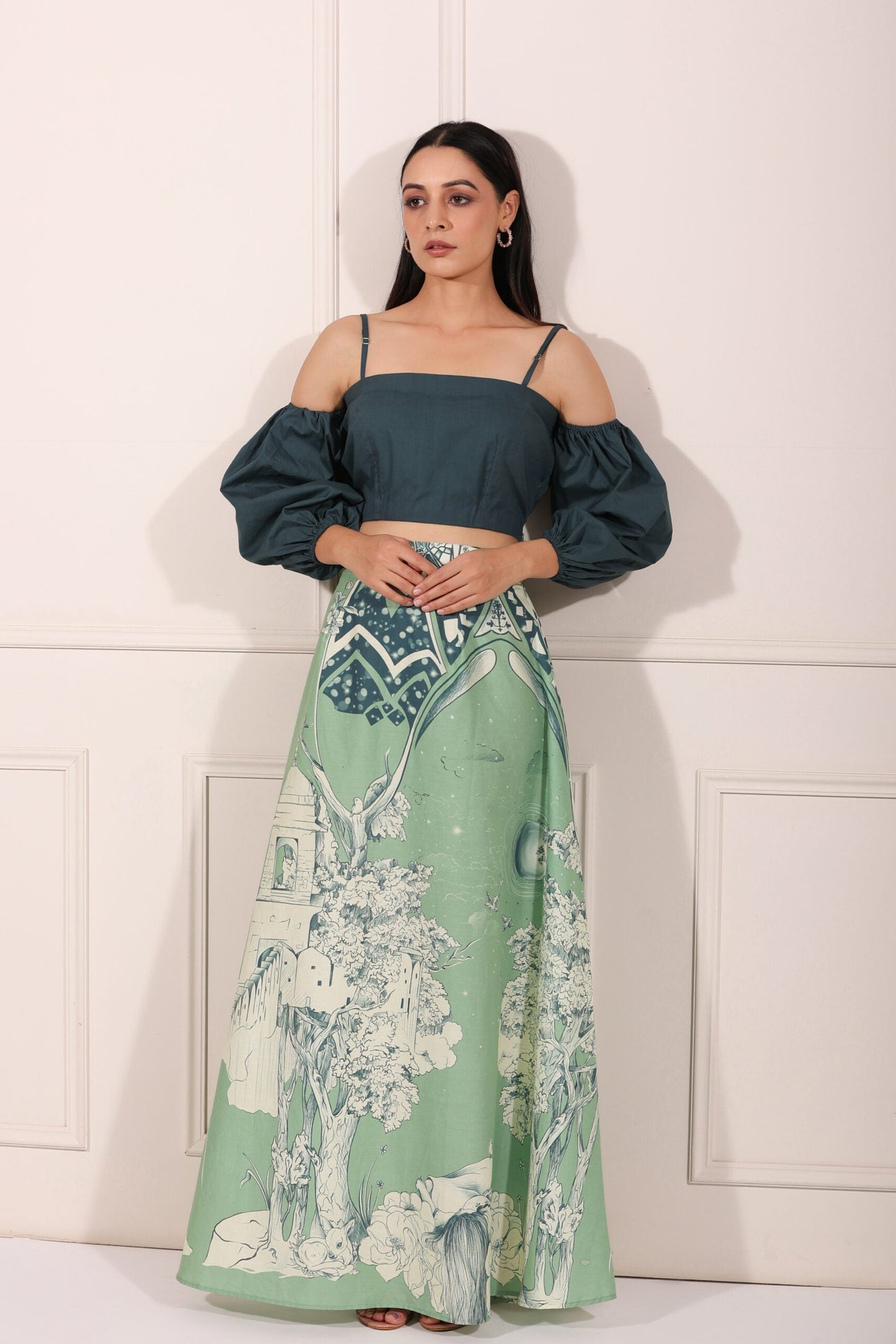 Stylish ethnic crop top and skirt set featuring a green skirt with artistic prints and a chic cropped top