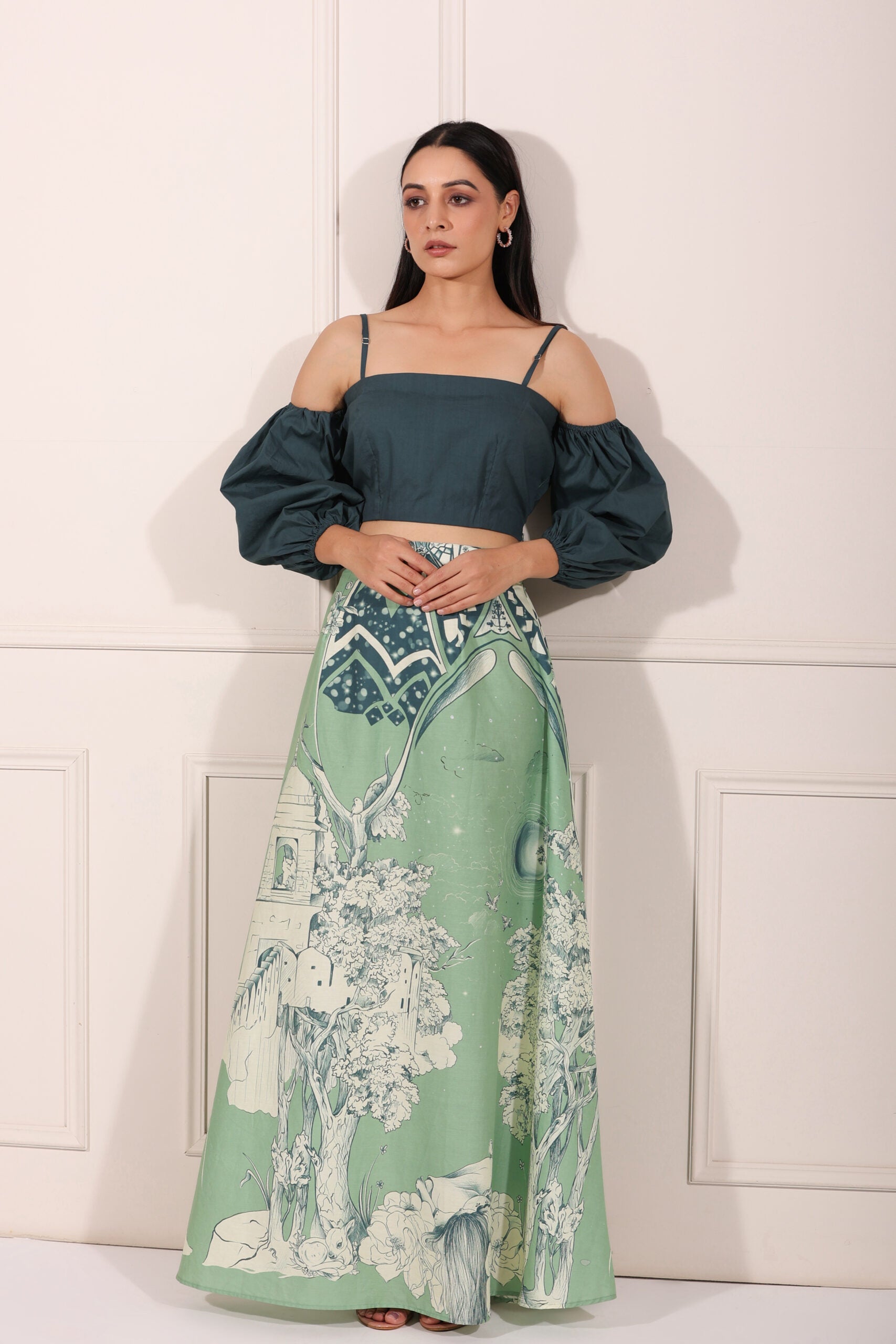 Stylish ethnic crop top and skirt set featuring a green skirt with artistic prints and a chic cropped top