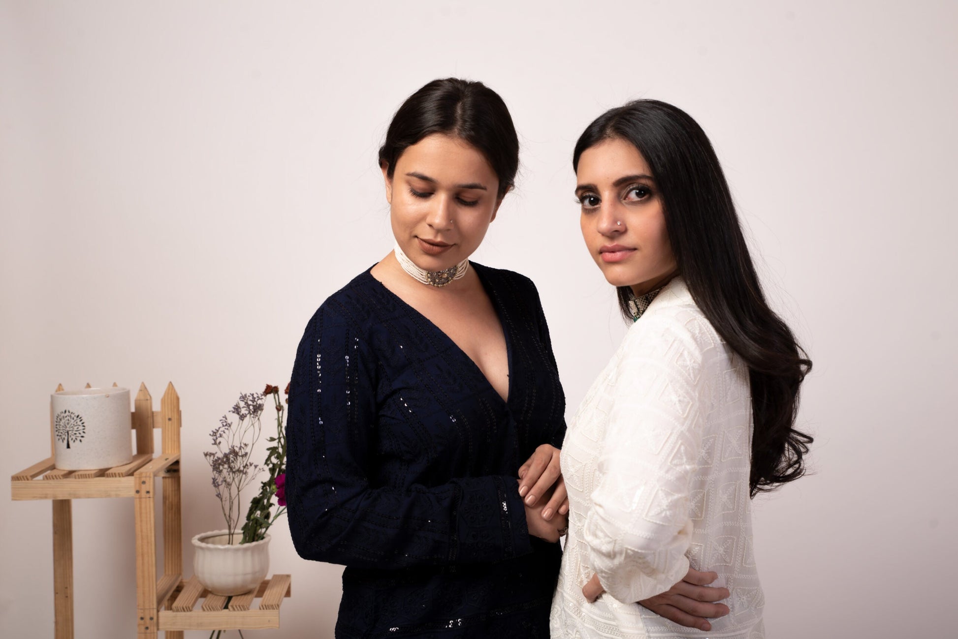 Two women modeling ethnic jackets for casual wear, showcasing intricate designs and styles
