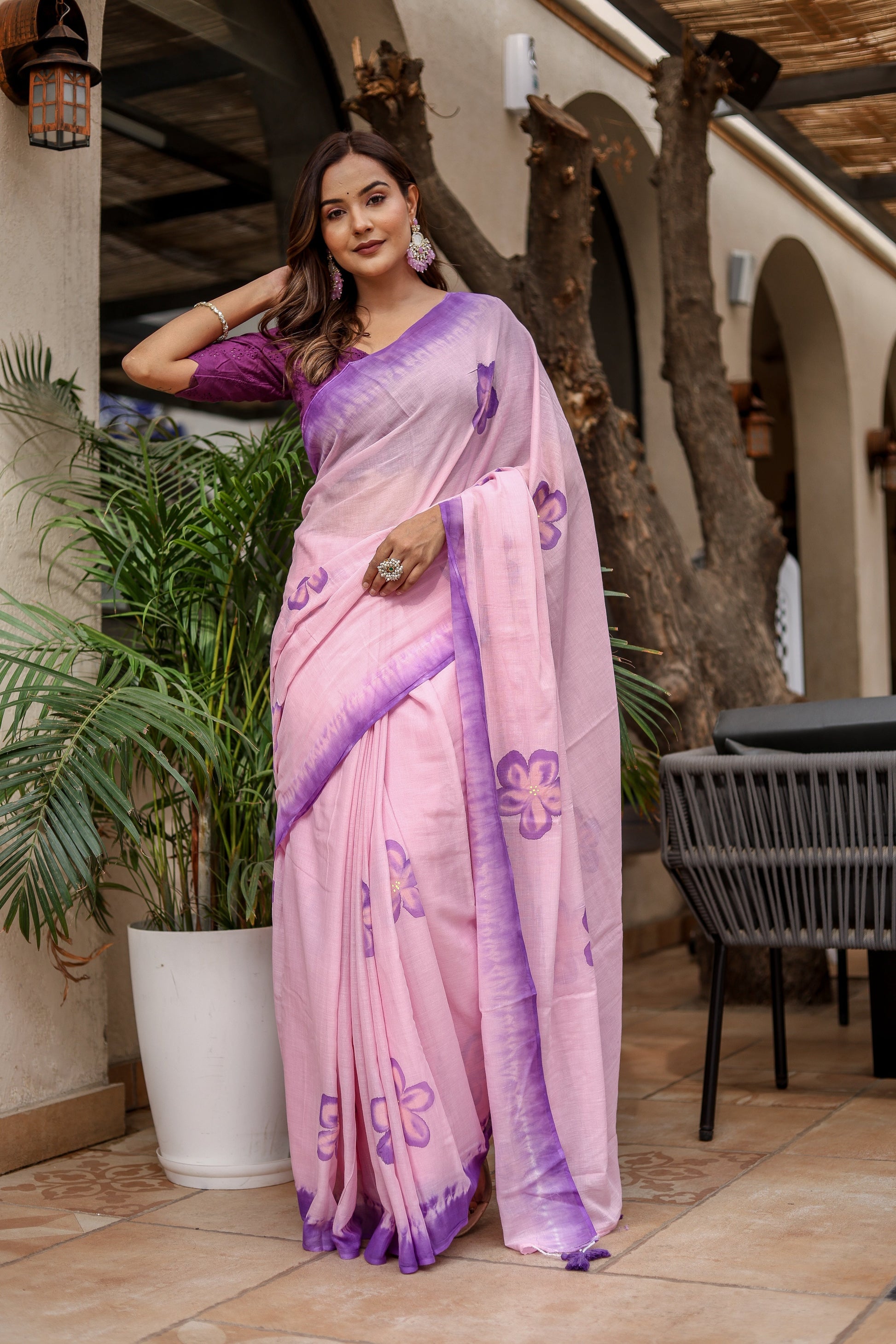 Elegant pink exclusive designer saree for parties with floral patterns and purple borders