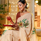Elegant woman wearing an exclusive handmade Indian saree with floral embroidery, celebrating a festive occasion