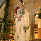 Exclusive handmade Indian saree in beige with floral embroidery, elegantly draped for festive occasions