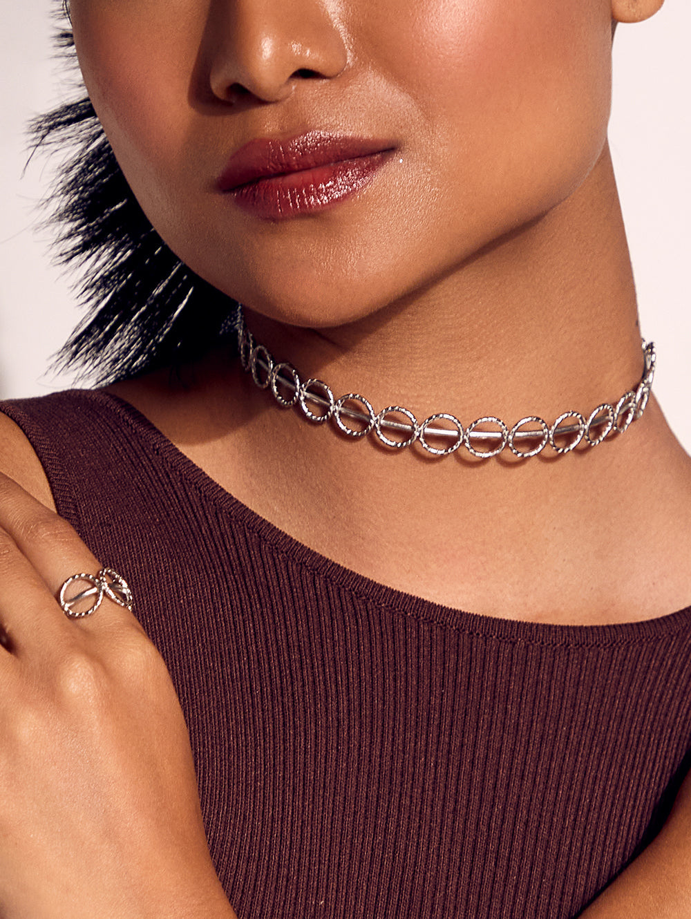 Stylera silver linked ring fashion accessory choker necklace on model in brown ribbed top with matching ring