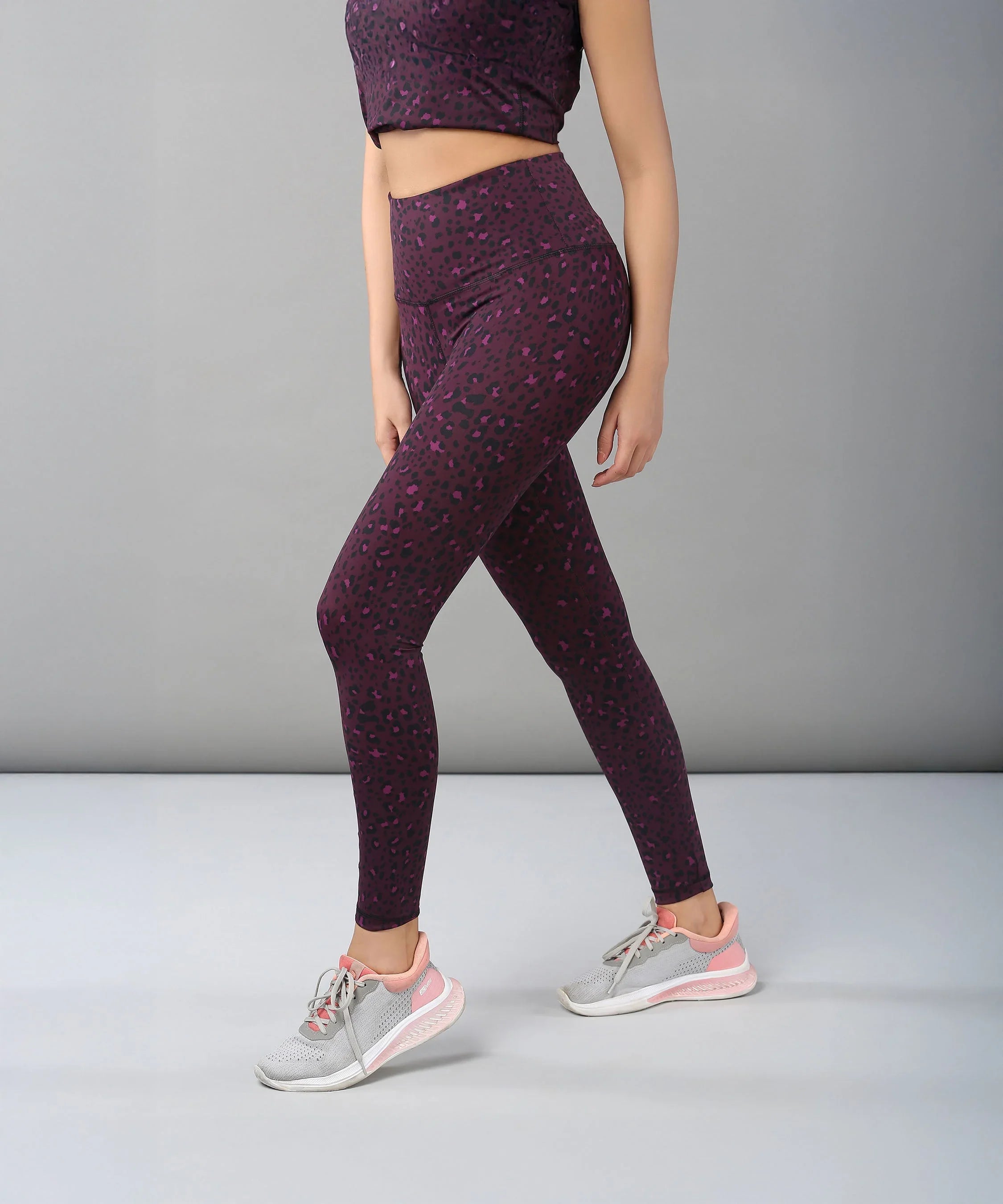 Stylera fashionable leggings for women in purple leopard print, paired with athletic shoes