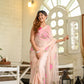 Floral organza saree for women in soft pink with vibrant floral embroidery, styled for a chic look