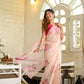 Elegant floral organza saree for women in light pink with vibrant floral designs and a graceful drape