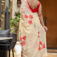 Elegant floral print cream saree with vibrant red flowers and tassels, perfect for festive occasions