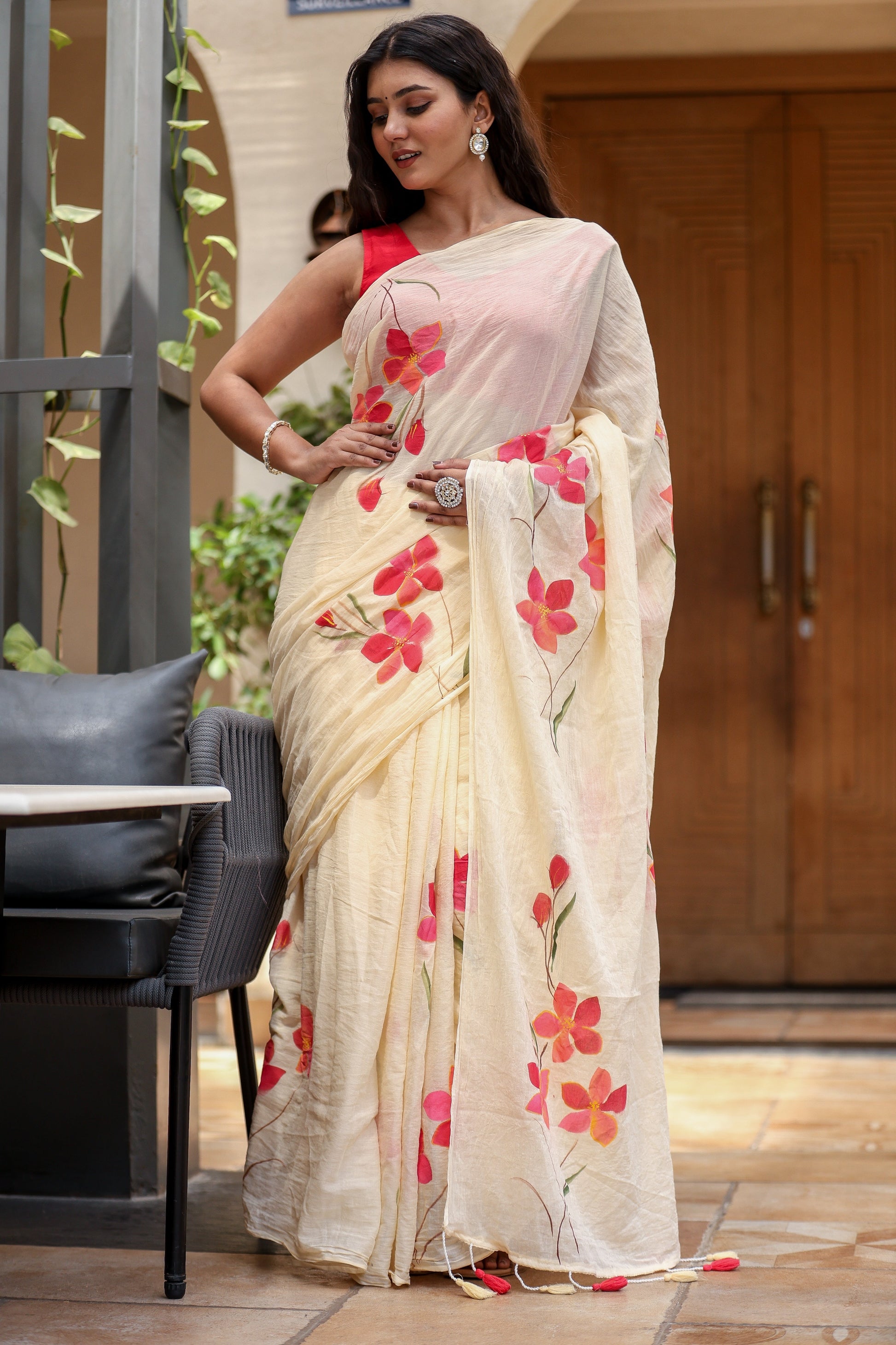 Floral print cream saree with vibrant pink flowers, perfect for festive occasions and elegant wear
