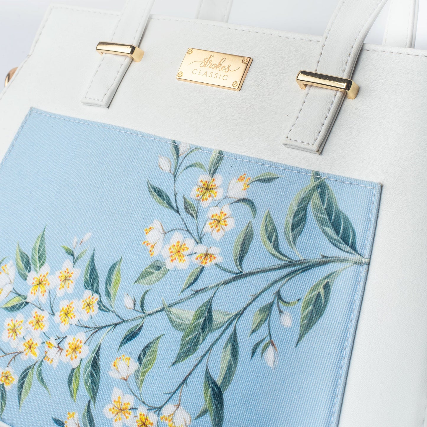 Floral print designer handbag by Stylera with beautiful flower patterns in soft blue and white