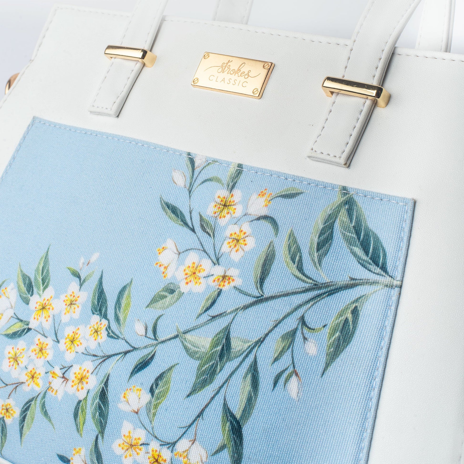 Floral print designer handbag by Stylera with beautiful flower patterns in soft blue and white