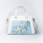 Stylera floral print designer handbag with elegant floral design on a light blue background
