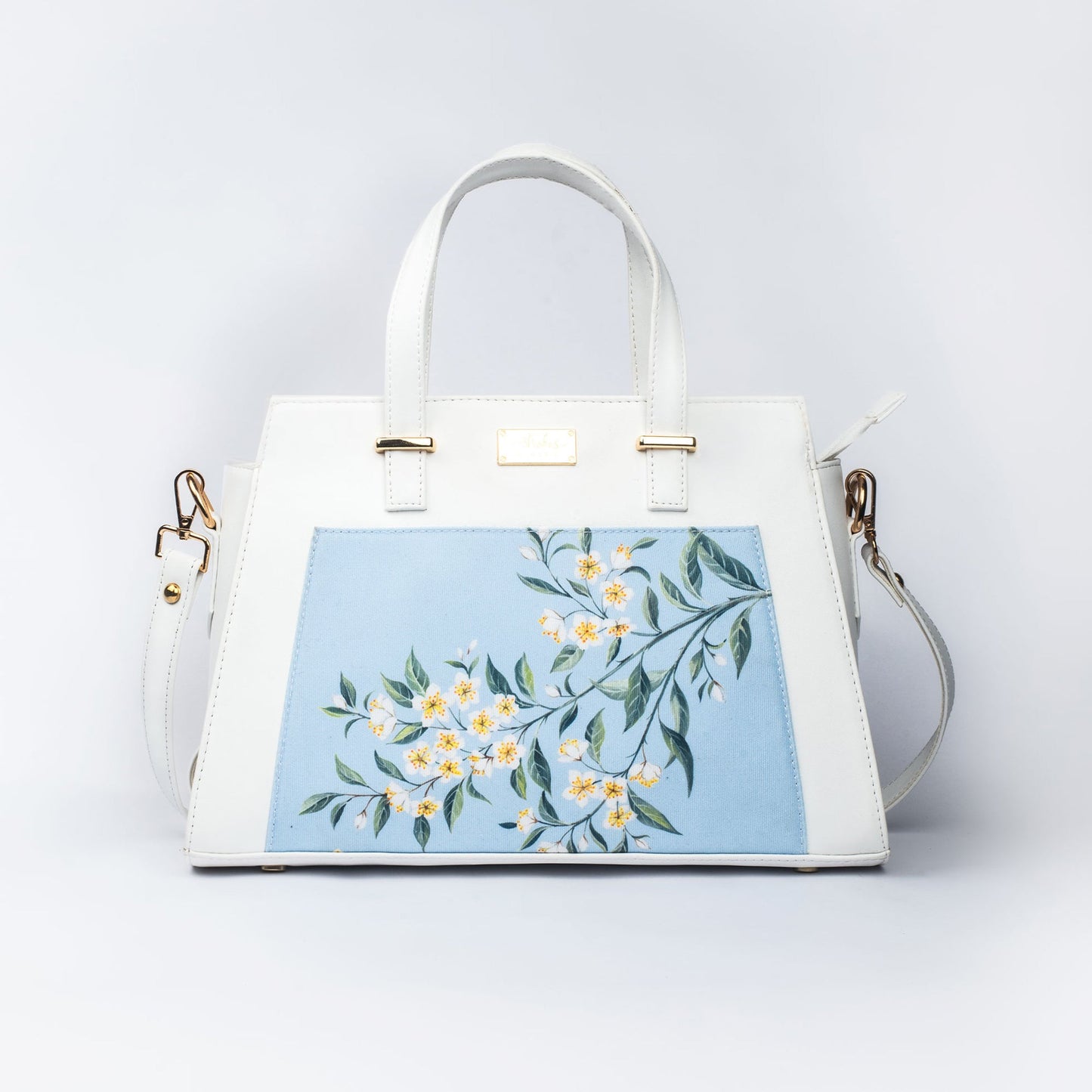 Stylera floral print designer handbag with elegant floral design on a light blue background