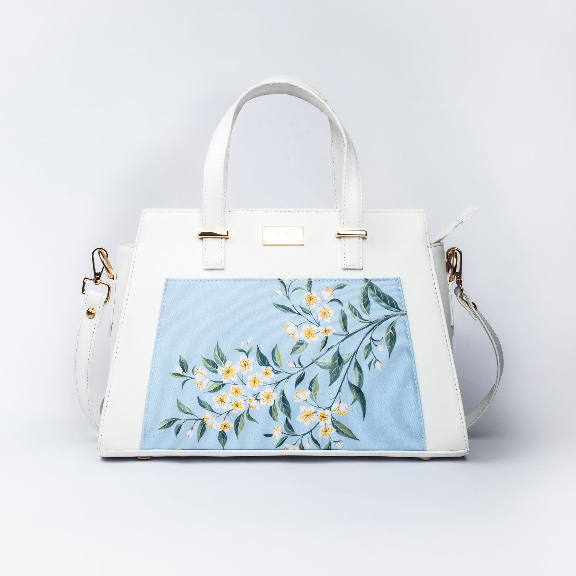 Stylera floral print designer handbag with elegant floral design on a light blue background