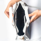 Open view of a floral print designer handbag showing spacious interior and organized pockets