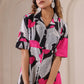 Floral print midi dress by Stylera with short sleeves and button-up design in vibrant black and pink
