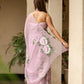 Elegant floral statement saree in soft pink with intricate floral patterns and flowing chiffon pallu
