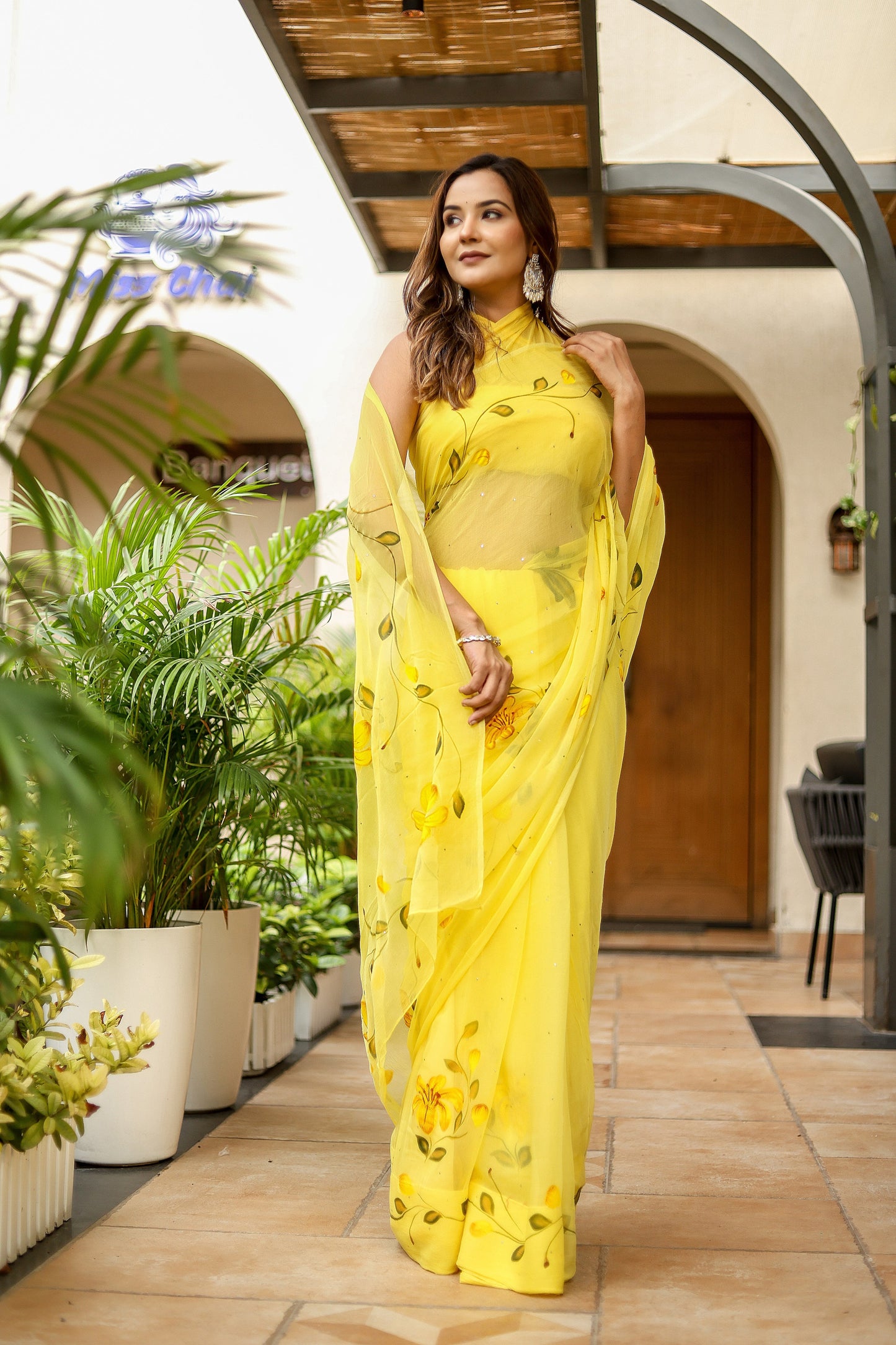 Elegant yellow floral viscose chiffon saree with mukaish work, perfect for festive occasions and parties