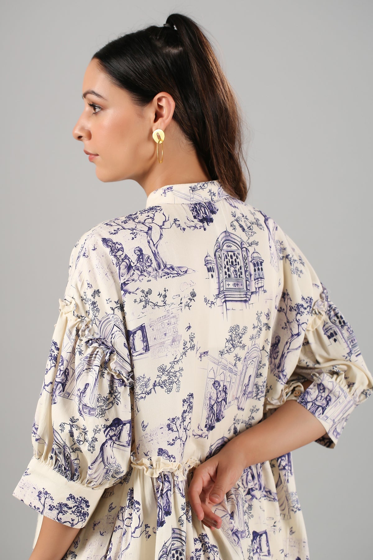 Back view of a Stylera flowy casual short sleeve dress in a vintage illustration print