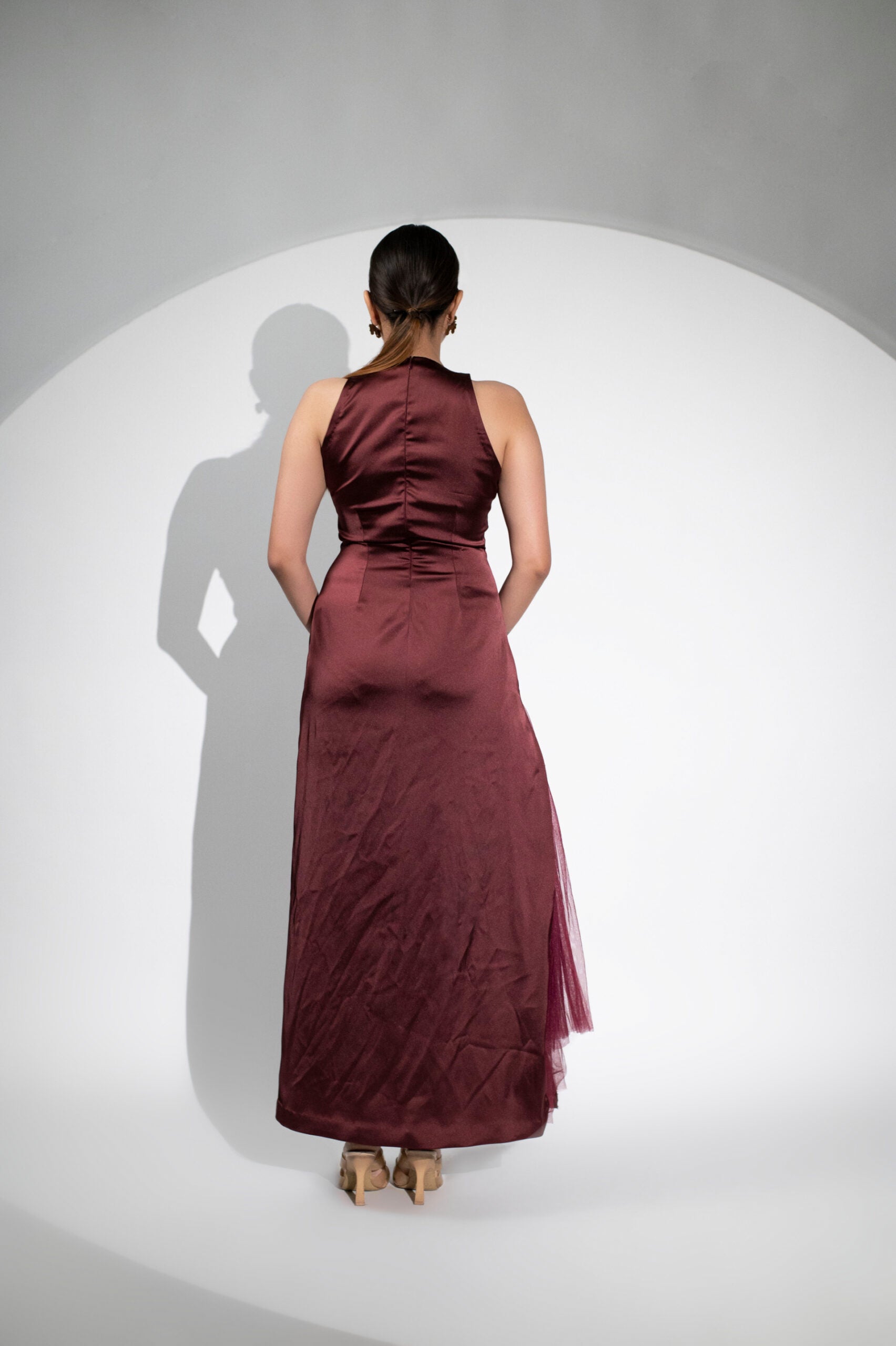 Elegant burgundy formal halter maxi gown for women with a flowing design and subtle train