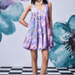 Stylera model wearing French lavender balloon dress with watercolor floral print and pearl necklace