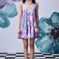 Stylera model wearing French lavender balloon dress floral print sleeveless bubble hem with pearl necklaces