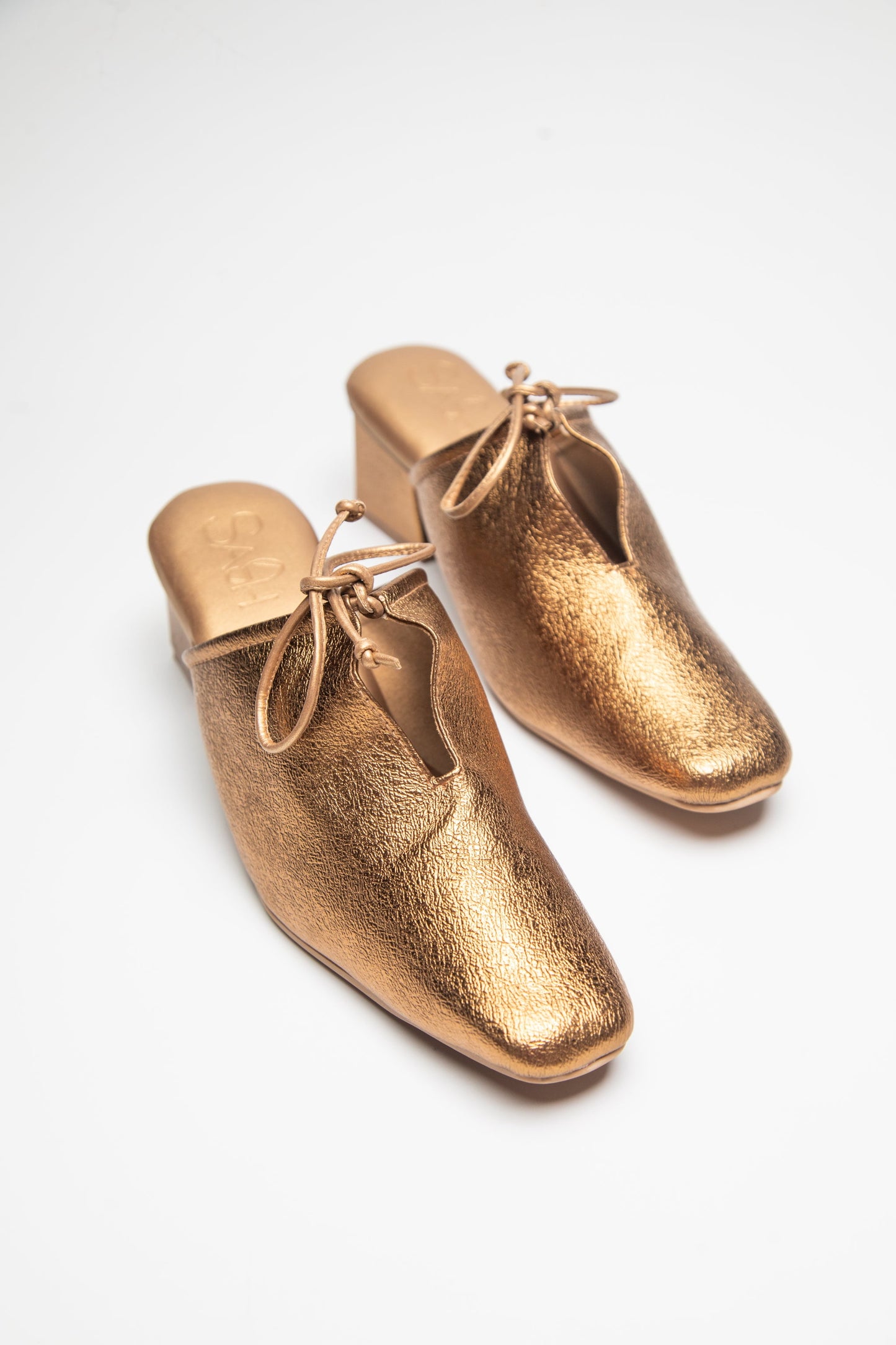 Stylera gold metallic heels designed as trendy slip-on shoes for women with a bow detail