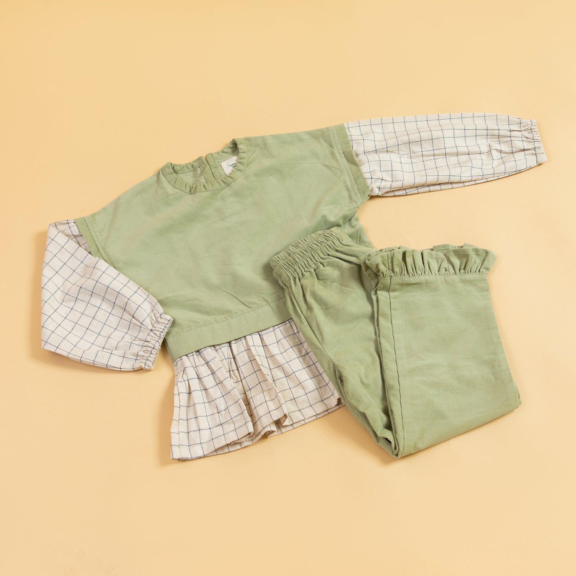 Stylera girls co-ord set featuring a green top with checkered sleeves and matching pants