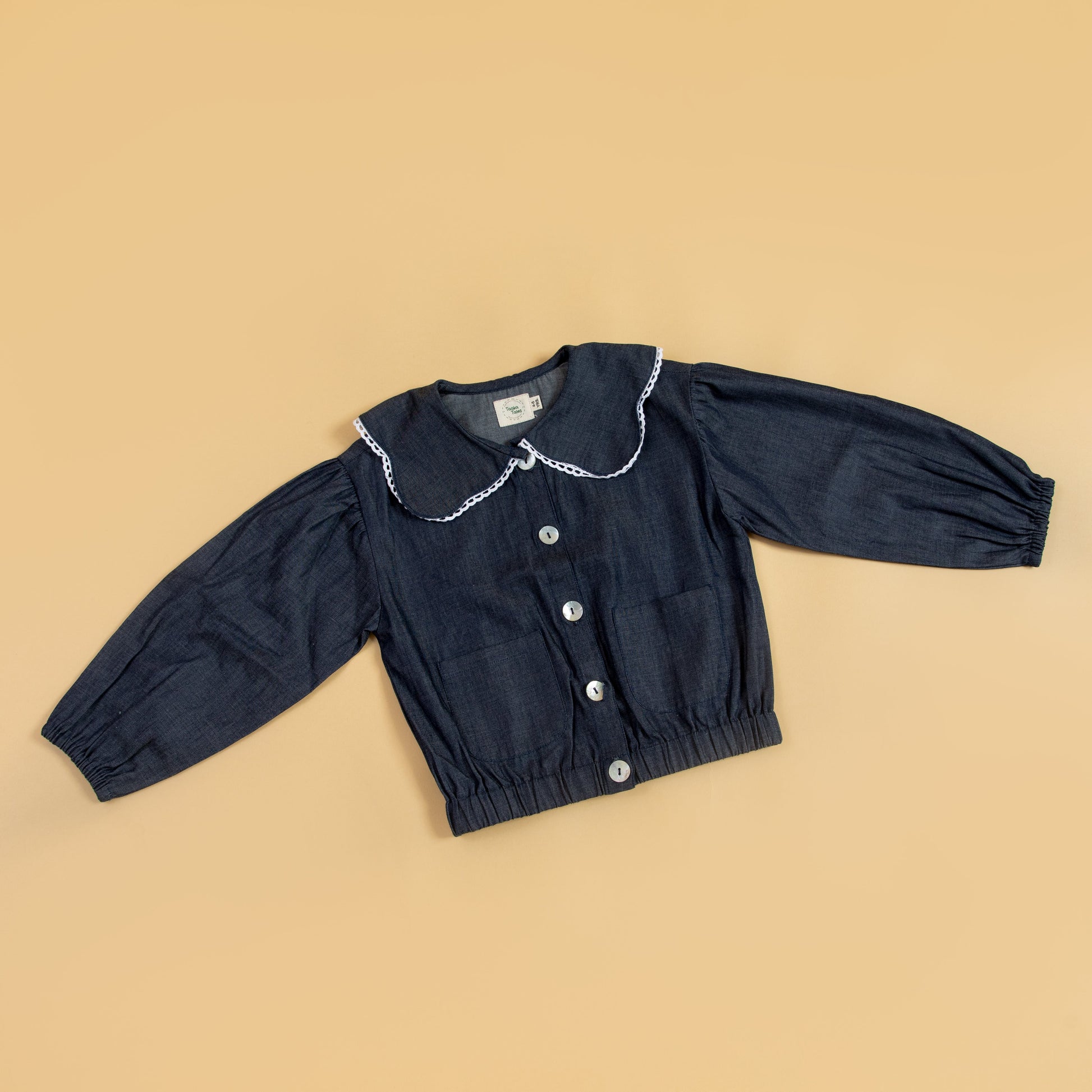 Cute girls denim jacket with a Peter Pan collar and button closure for stylish kids