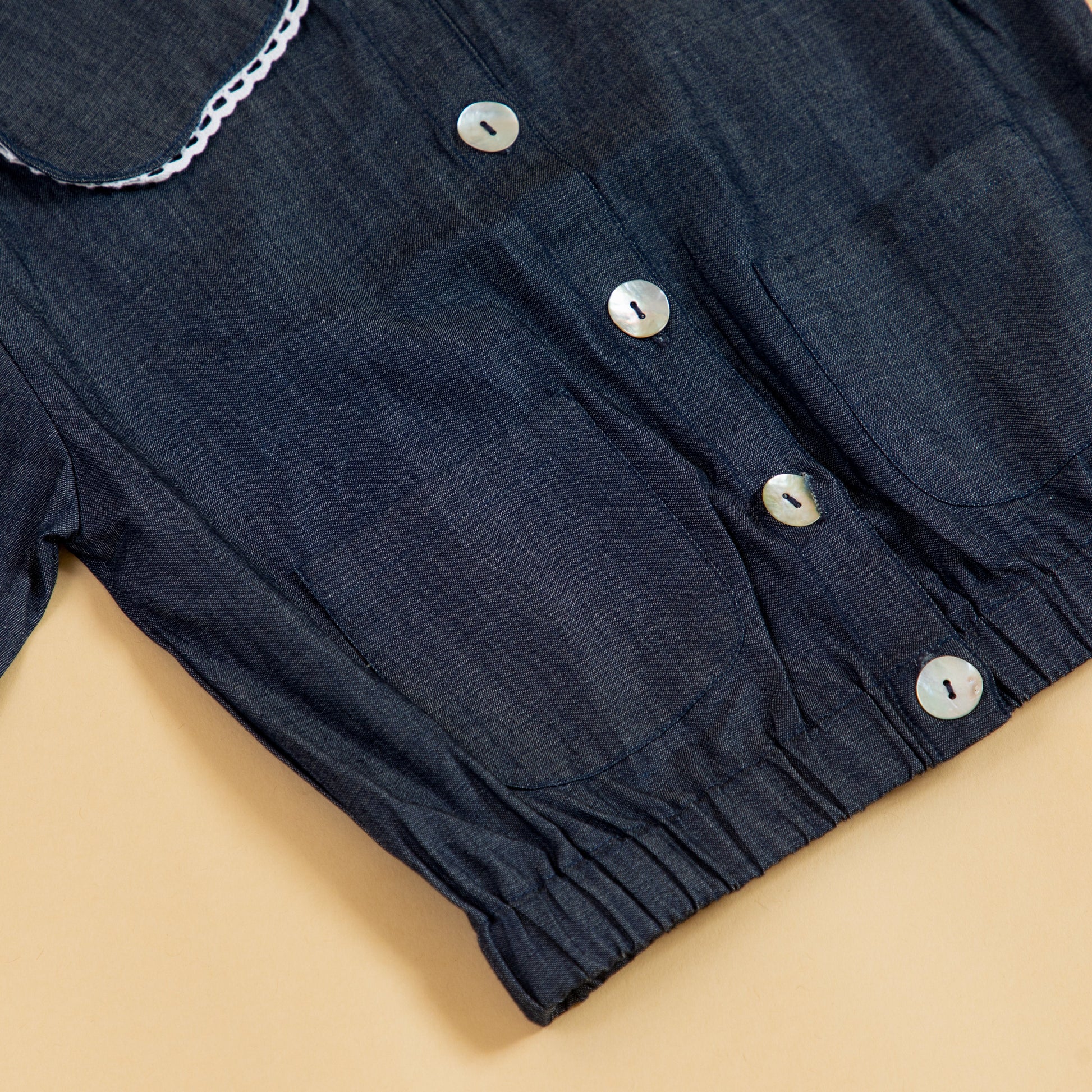 Girls denim jacket with button closure and ruffled collar, perfect for casual outfits