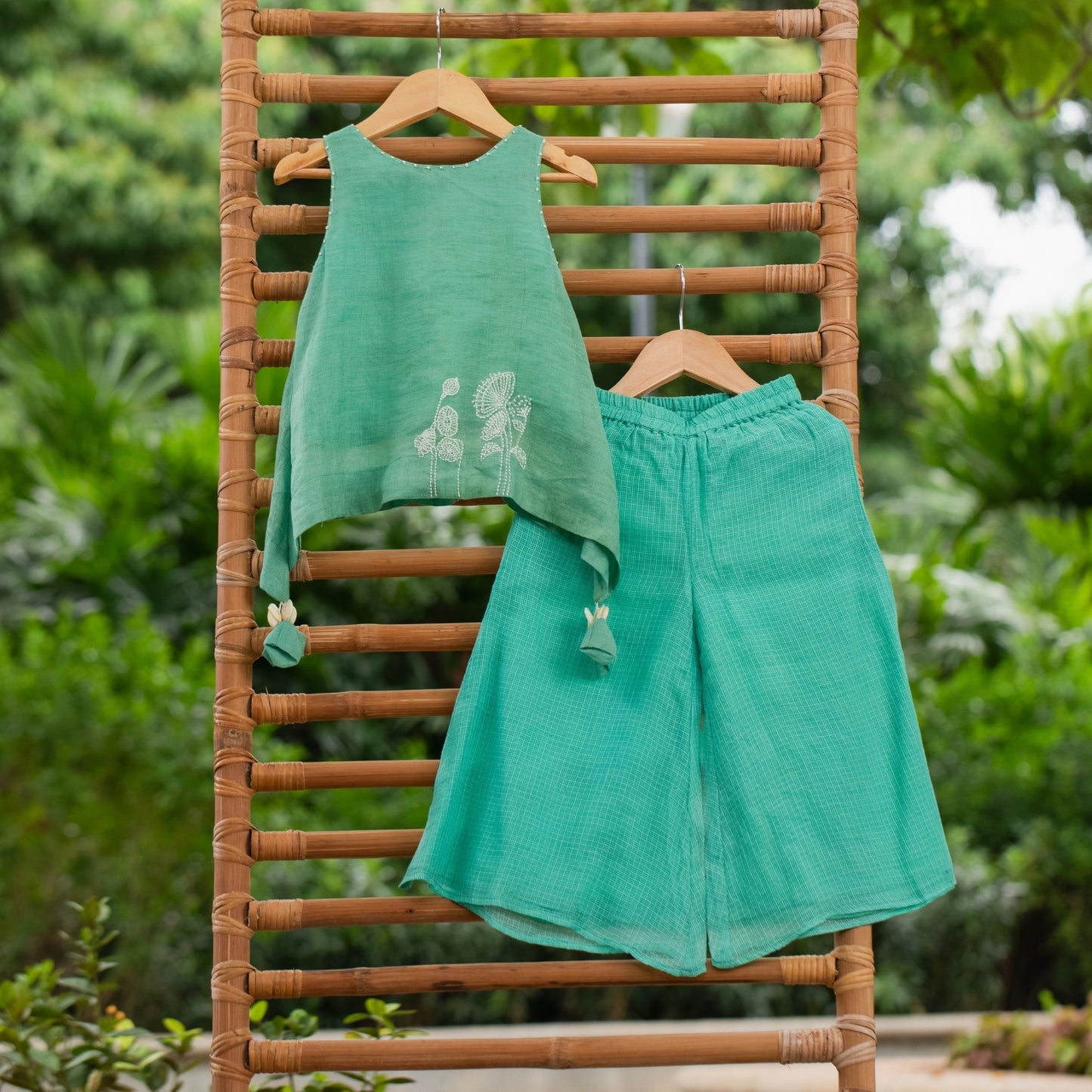 Girls firozi palazzo set featuring a sleeveless top with floral print and matching wide-leg palazzo pants