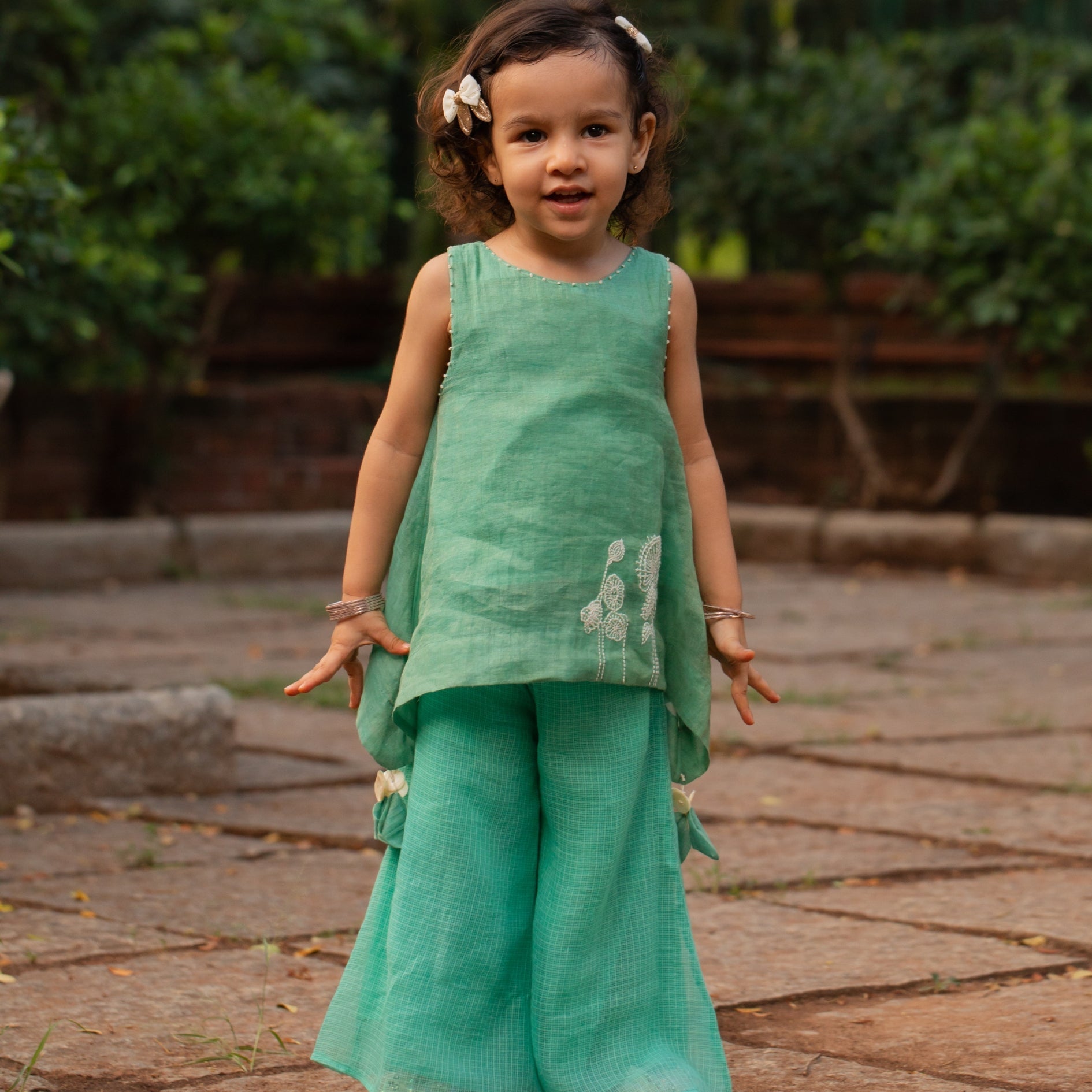 Girls firozi palazzo set featuring a stylish top and wide-leg pants in a vibrant green shade