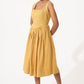 Stylera gold cotton corset dress with square neckline and midi skirt worn by model