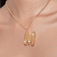 Stylera gold letter M necklace pendant with textured gold and small pearl accents on delicate chain