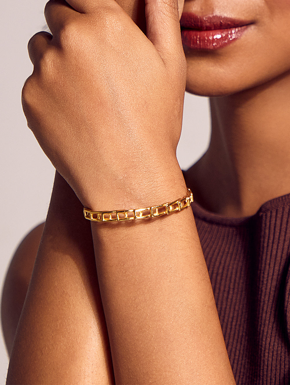 Stylera gold link bracelet for women on model wrist close up polished rectangular chain links