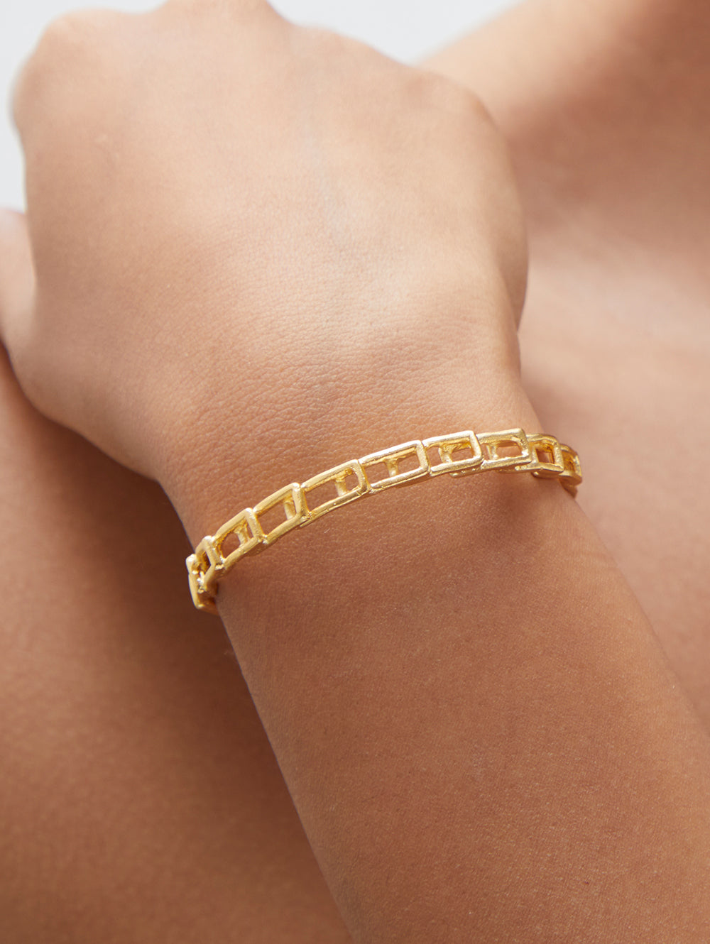 Stylera delicate gold link bracelet for women shown on wrist with rectangular chain links
