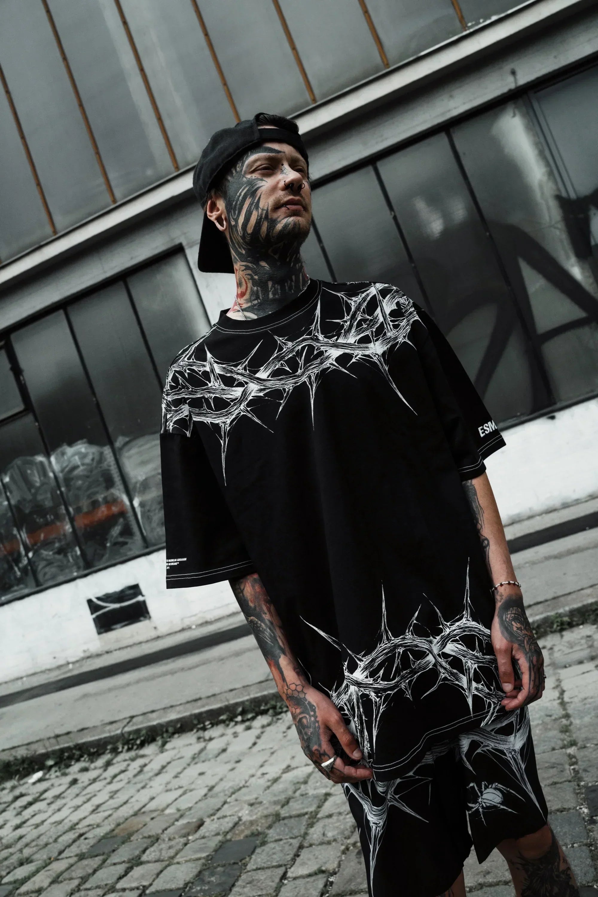 Urban streetwear styling featuring the gothic oversized tshirt with a drop shoulder boxy fit.