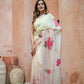 Stylera Graceful Tints floral saree in soft peach with vibrant rose prints, styled elegantly on a model
