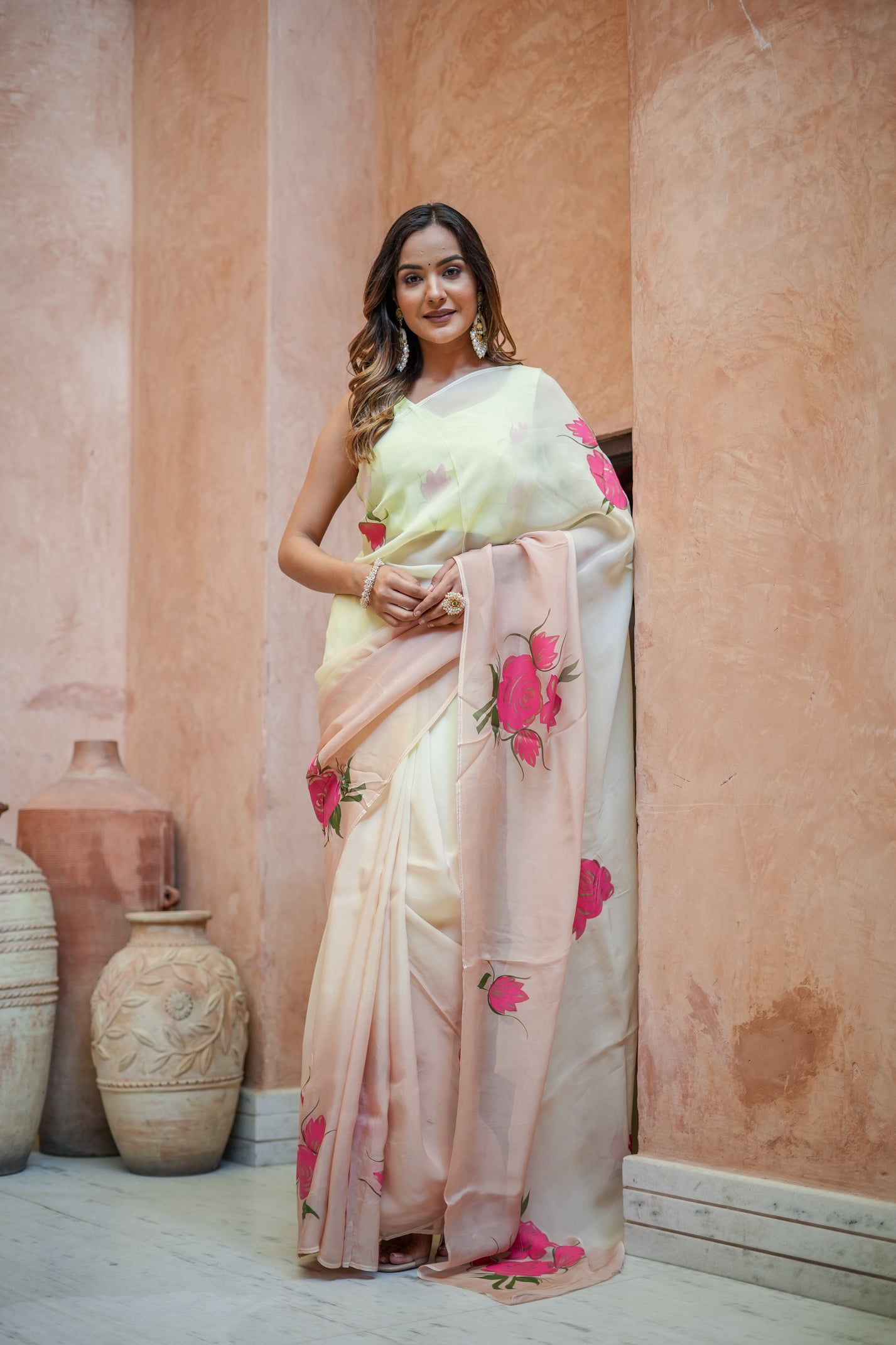 Model wearing a Graceful Tints floral saree featuring pastel shades and vibrant floral embroidery