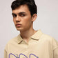 Stylera beige graphic polo shirt for men on model with purple CAS insect print and relaxed oversized fit